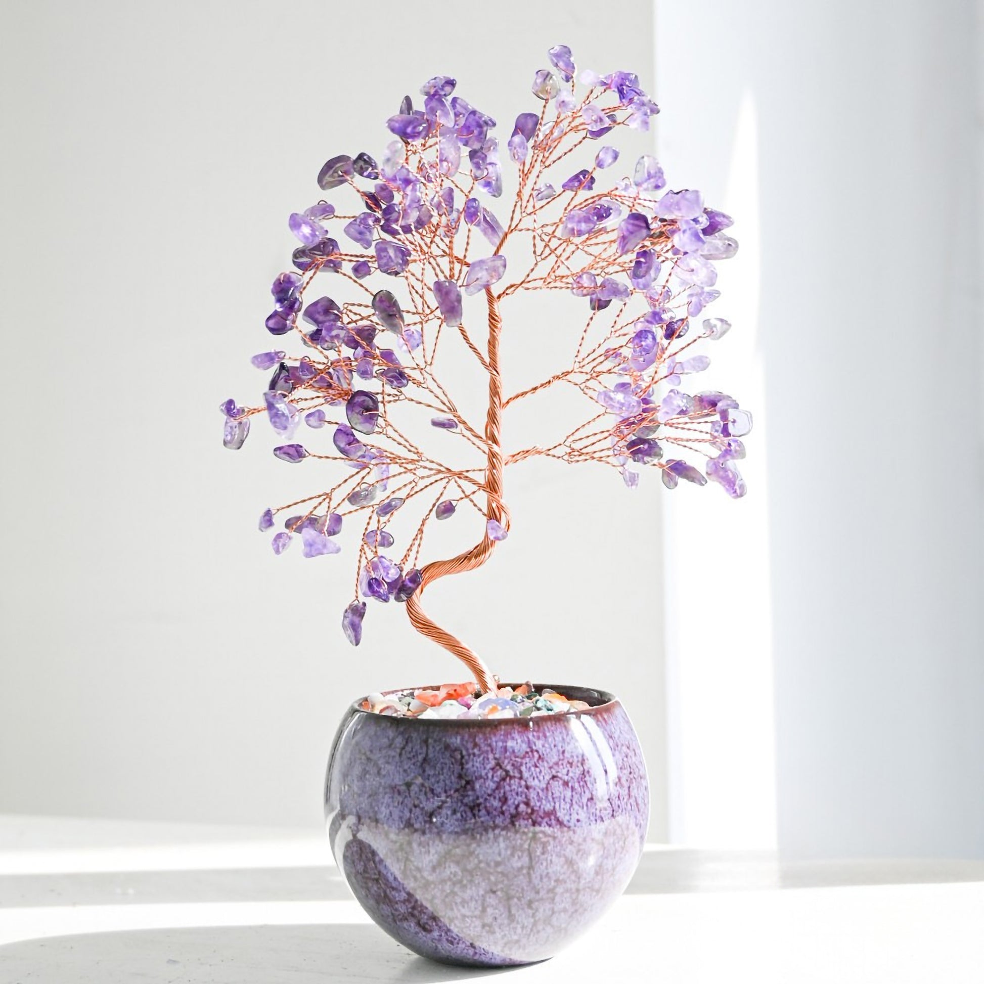 Amethyst Feng Shui crystal money tree with copper branches in a tall decorative pot filled with colorful agate gemstone chips for home decor, energy healing, and positive vibes