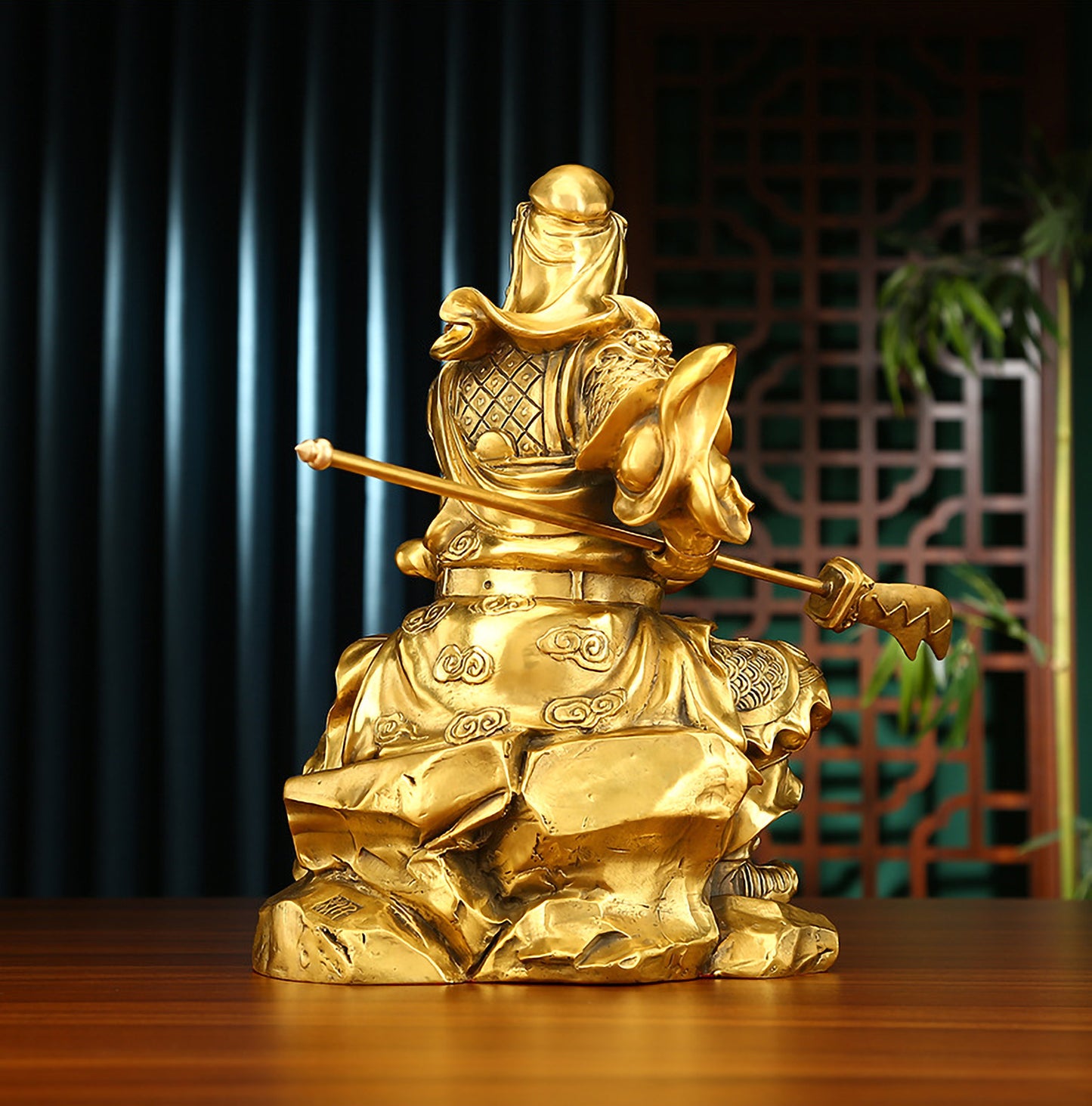 Back view of brass Guan Yu statue showing hollow design and detailed warrior robe, holding the Green Dragon Crescent Blade.