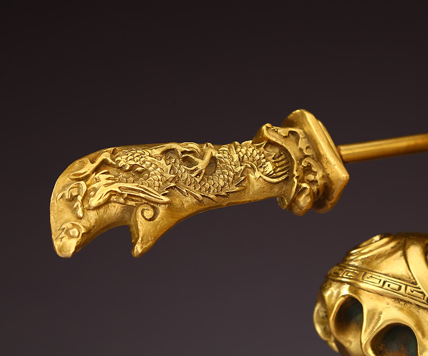 Detailed close-up of the Green Dragon Crescent Blade on brass Guan Yu statue with hollow structure.