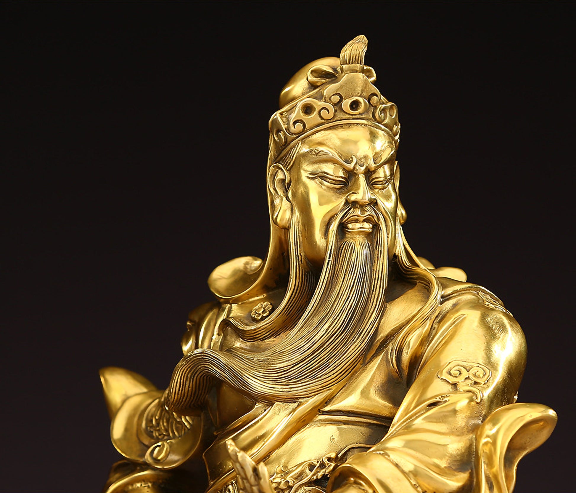 Close-up of upper body of brass Guan Yu statue highlighting hollow design, facial expression, intricate armor details, and the Green Dragon Crescent Blade.