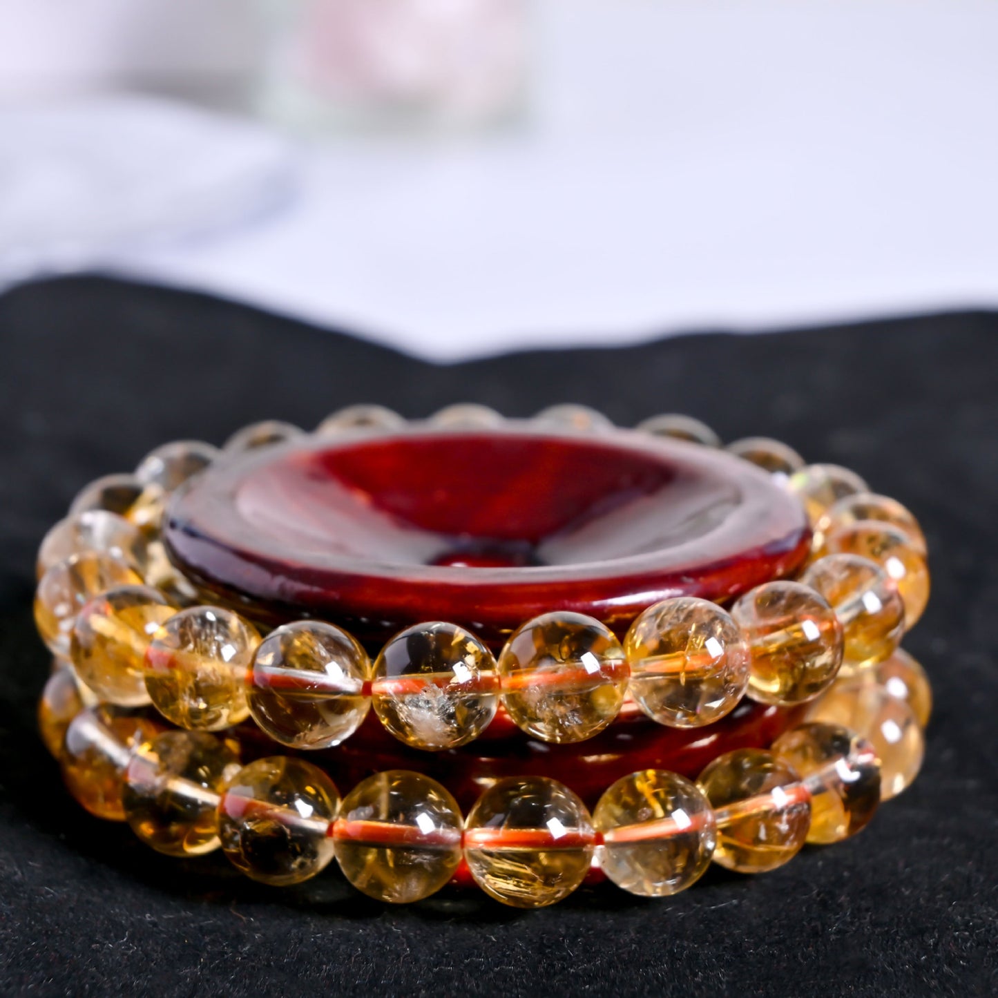 Set of two citrine bracelets on wooden display, natural yellow crystal stretch bracelets for wealth and abundance