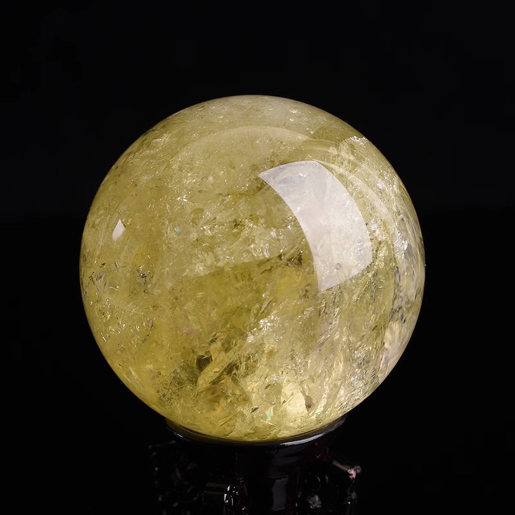 Close-up of citrine crystal sphere on wooden stand for Feng Shui and home decoration