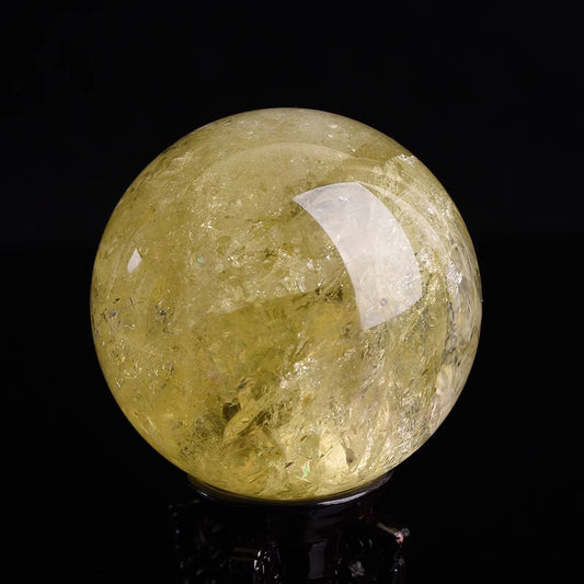 Close-up of citrine crystal sphere on wooden stand for Feng Shui and home decoration