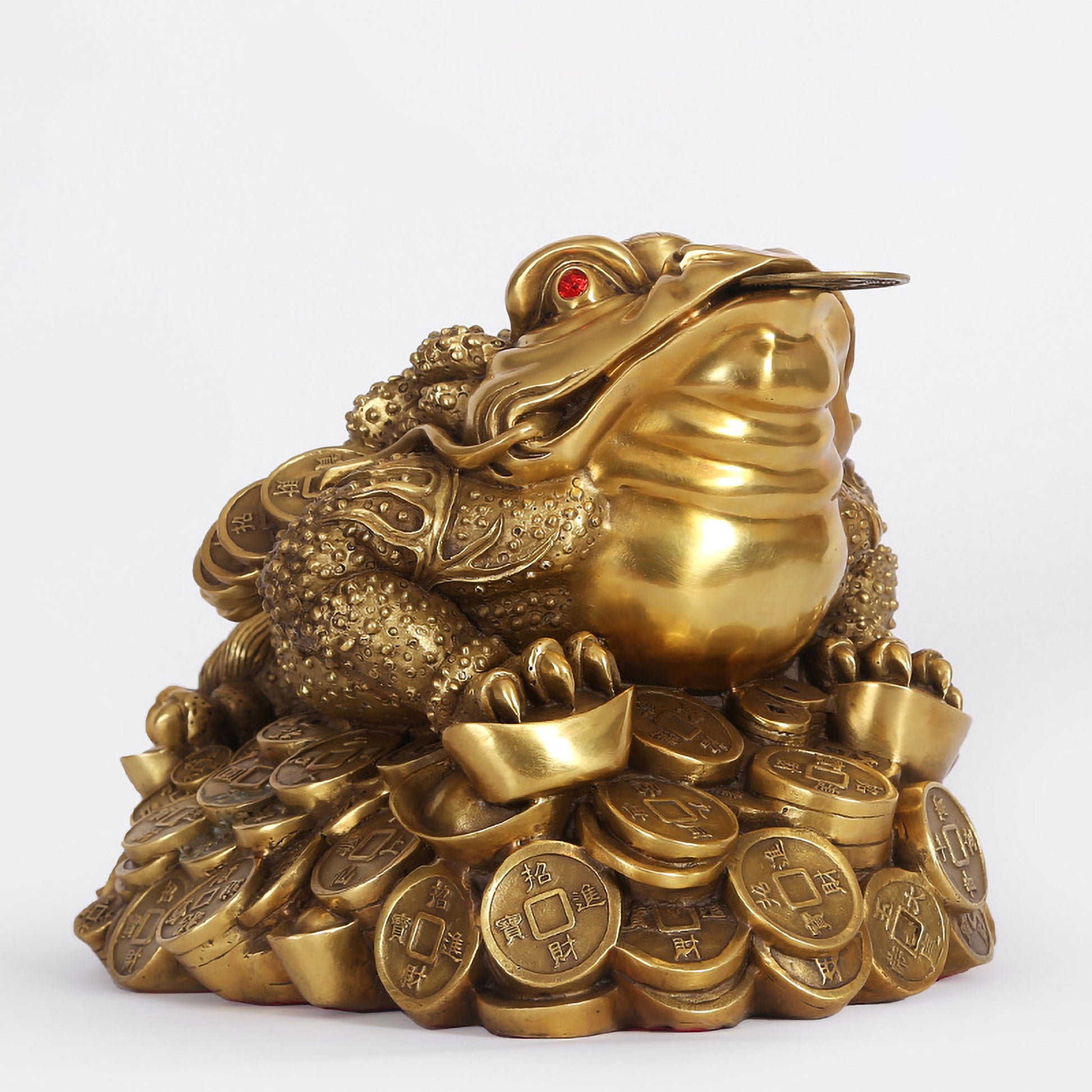 Front view of a large hollow brass Feng Shui three-legged toad figurine with detailed coin patterns for attracting wealth