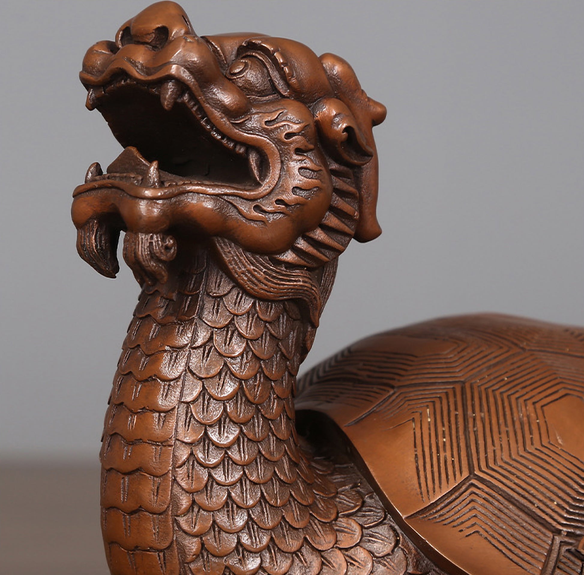 Close-up of the dragon head carving on a medium hollow bronze dragon turtle