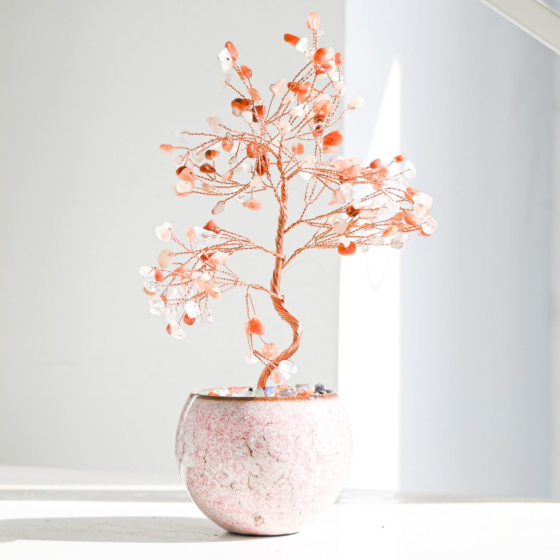 Red Agate Feng Shui crystal money tree in a tall decorative pot, accented with colorful gemstone pebbles, representing strength, protection, and grounding home energy