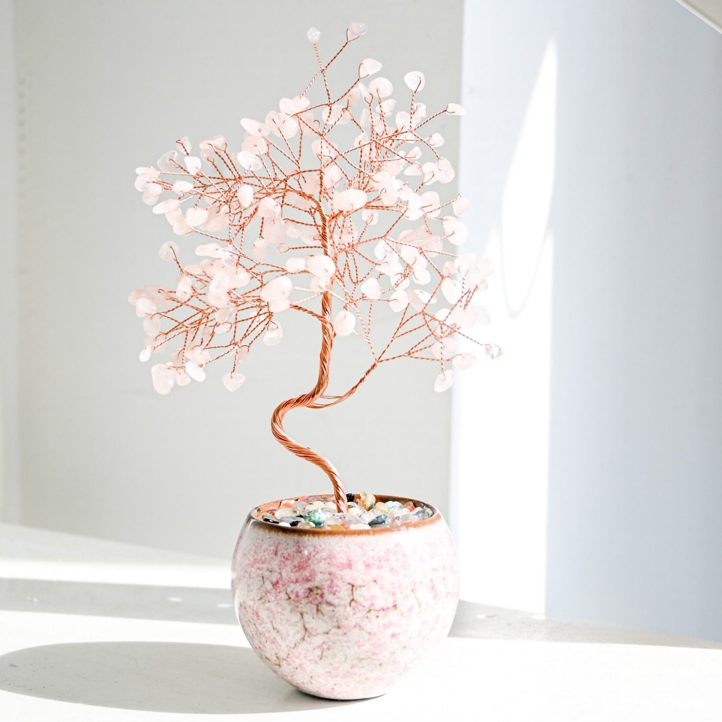 Rose Quartz Feng Shui crystal money tree with handcrafted copper branches, set in a tall pot with multicolor stones for love, relationship harmony, and emotional healing energy