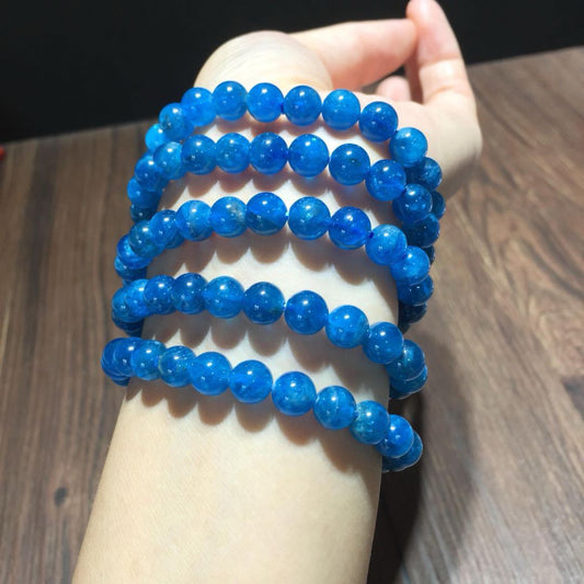 Multiple natural blue apatite crystal bracelets stacked on a hand, 8mm beads energy stone jewelry